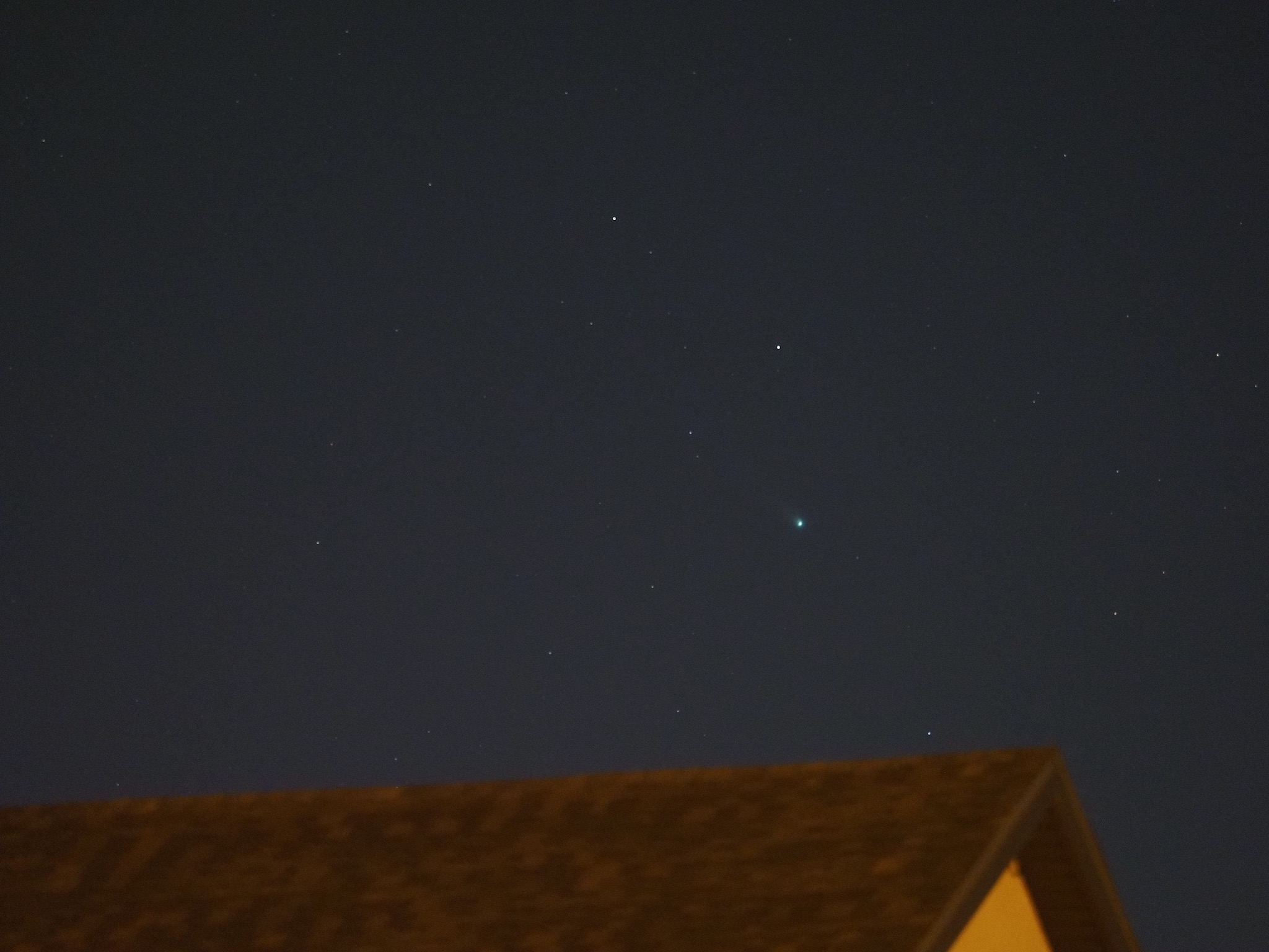 Comet Leonard over the roof of the house across the street.