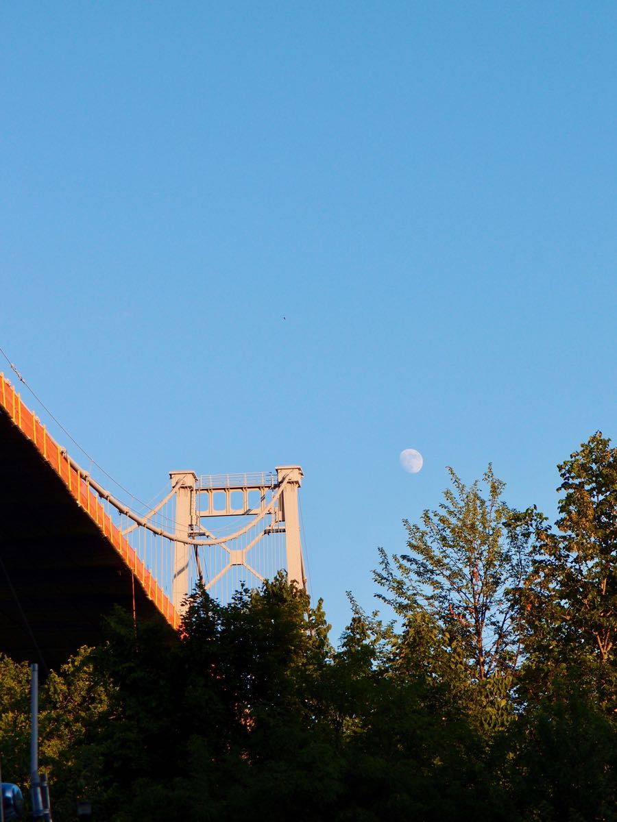 Gibbous moon to the right of a truss of the Kingston-Port Ewen Suspension Bridge.