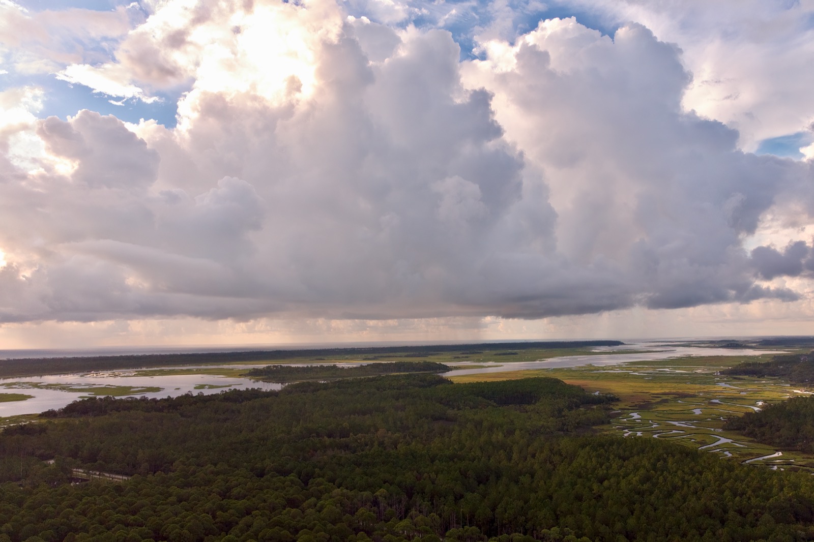 Drone photo of cumulus clouds raining over the intracoastal waterway