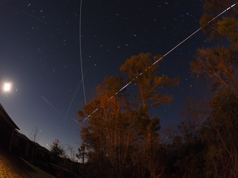 Live composite image of star trails and the light of the ISS across the Florida sky.