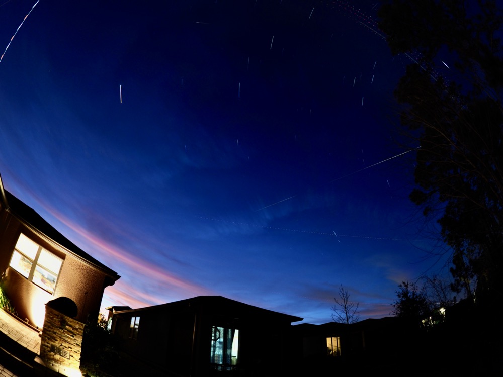 Live composite shot of the International Space Station passing overhead. Light trail is short because sky glow and high clouds.