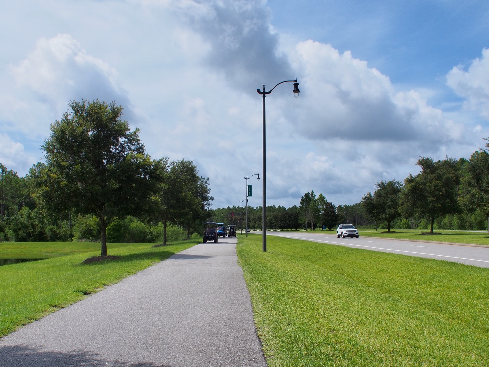 Some golf carts on a multi-purpose path.