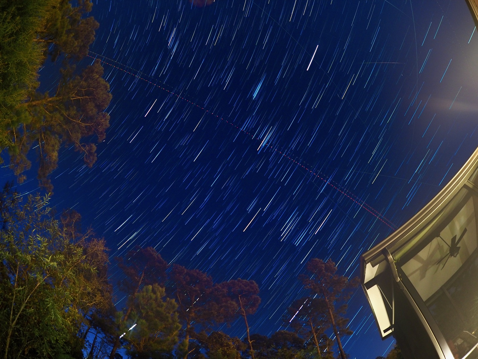 Star trails visible overhead along with aircraft lights, satellites and possibly a meteor
