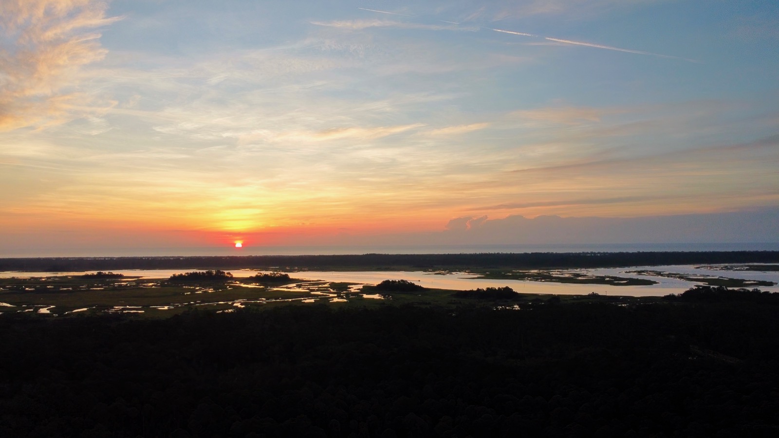 Sunrise looking over the Tolomato River toward the Atlantic Ocean from a DJI mini 2 drone. Lower limb of the sun touching the horizon