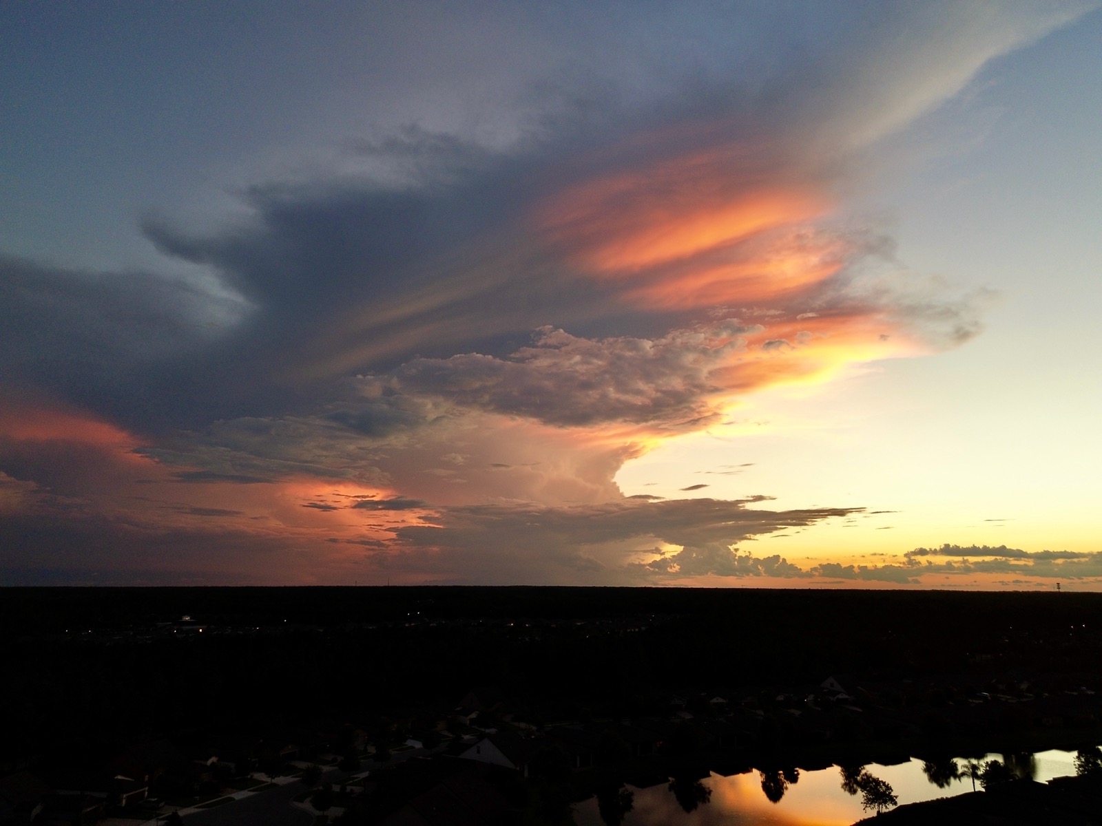 Cloud illuminated by the sun below the horizon in evening.