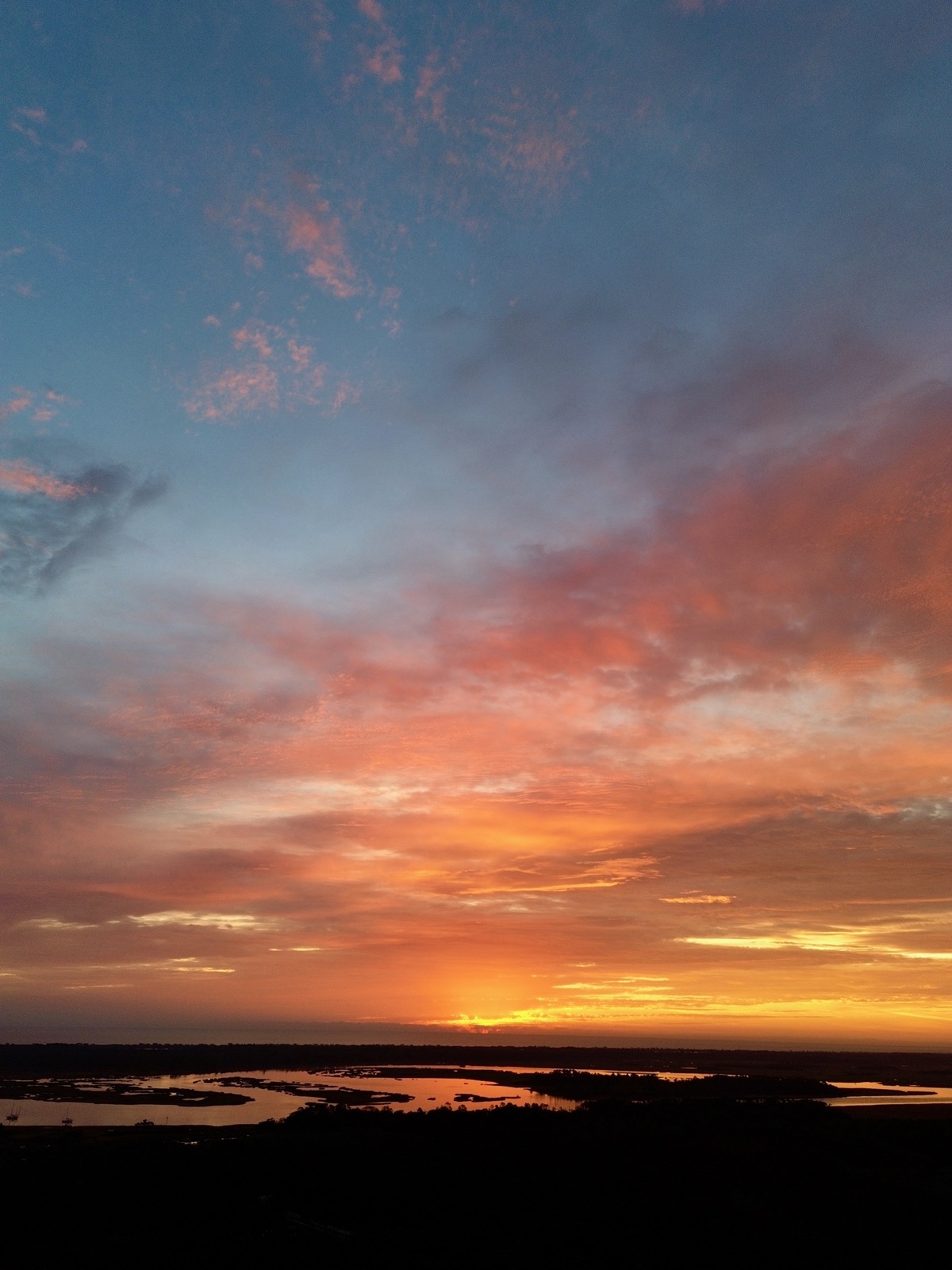 Clouds illuminated from below by morning sunrise above the Tolomato River