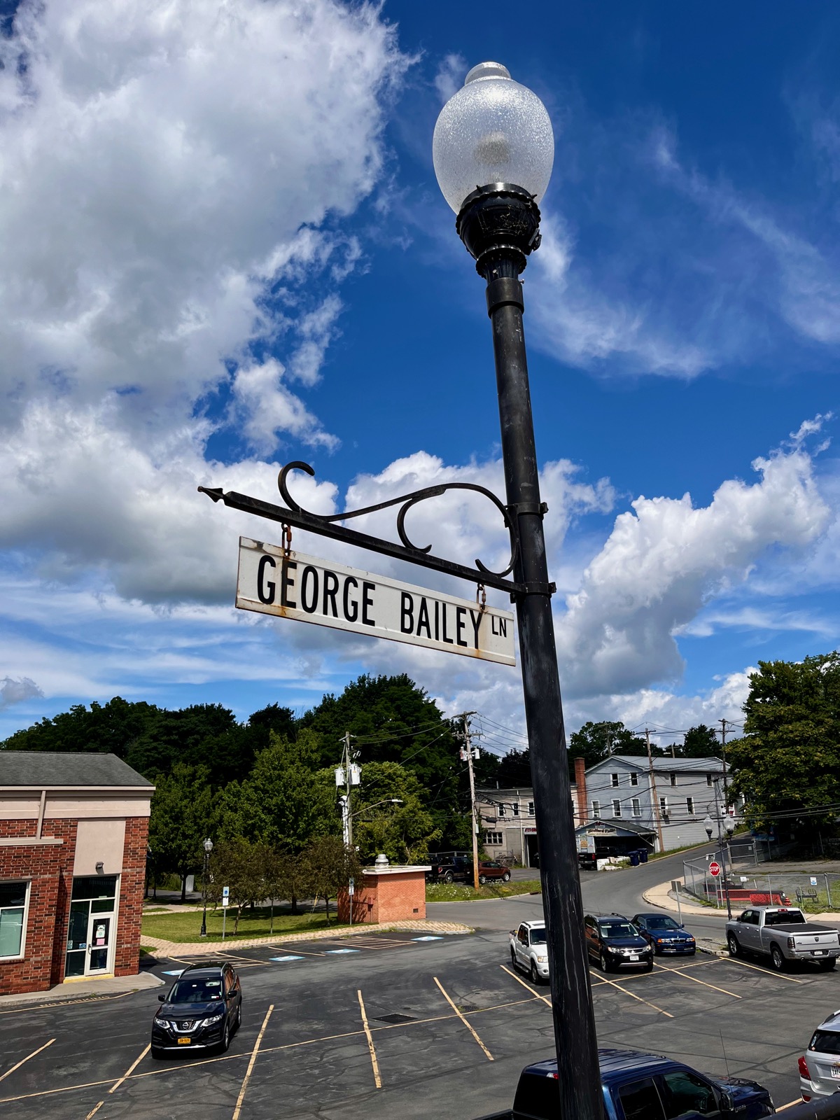 Photo of a lamppost with a street sign reading 