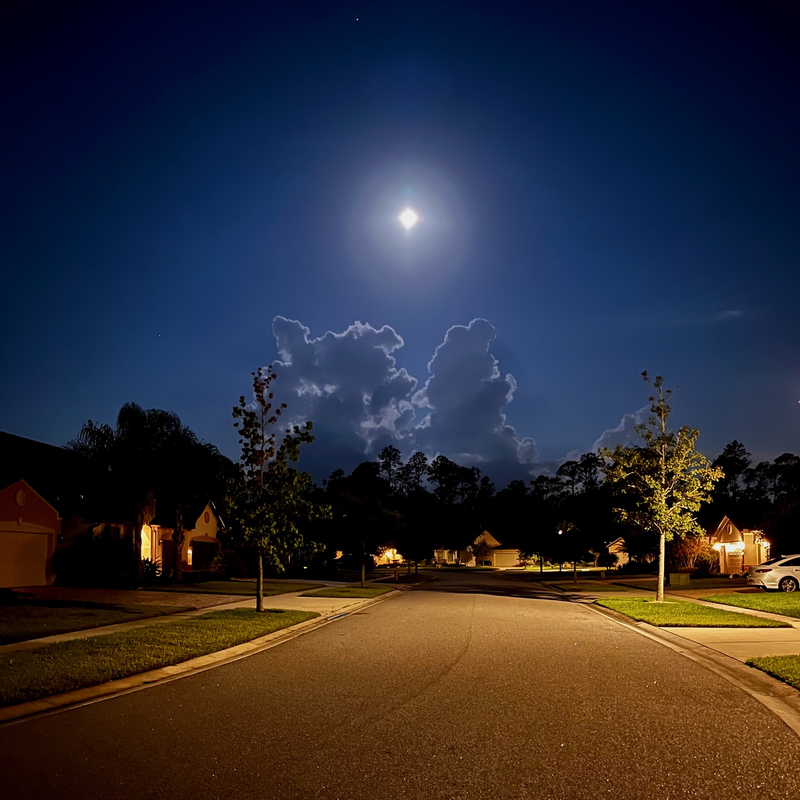 iPhone pic of the full moon between cloud towers