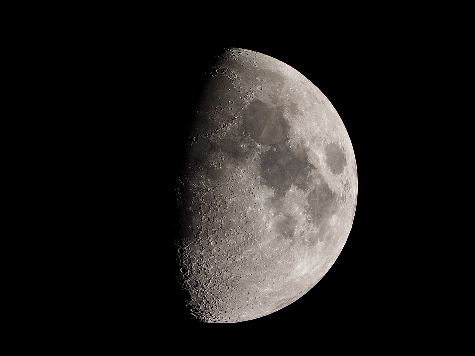 Telephoto closeup of waxing gibbous moon 65% illuminated
