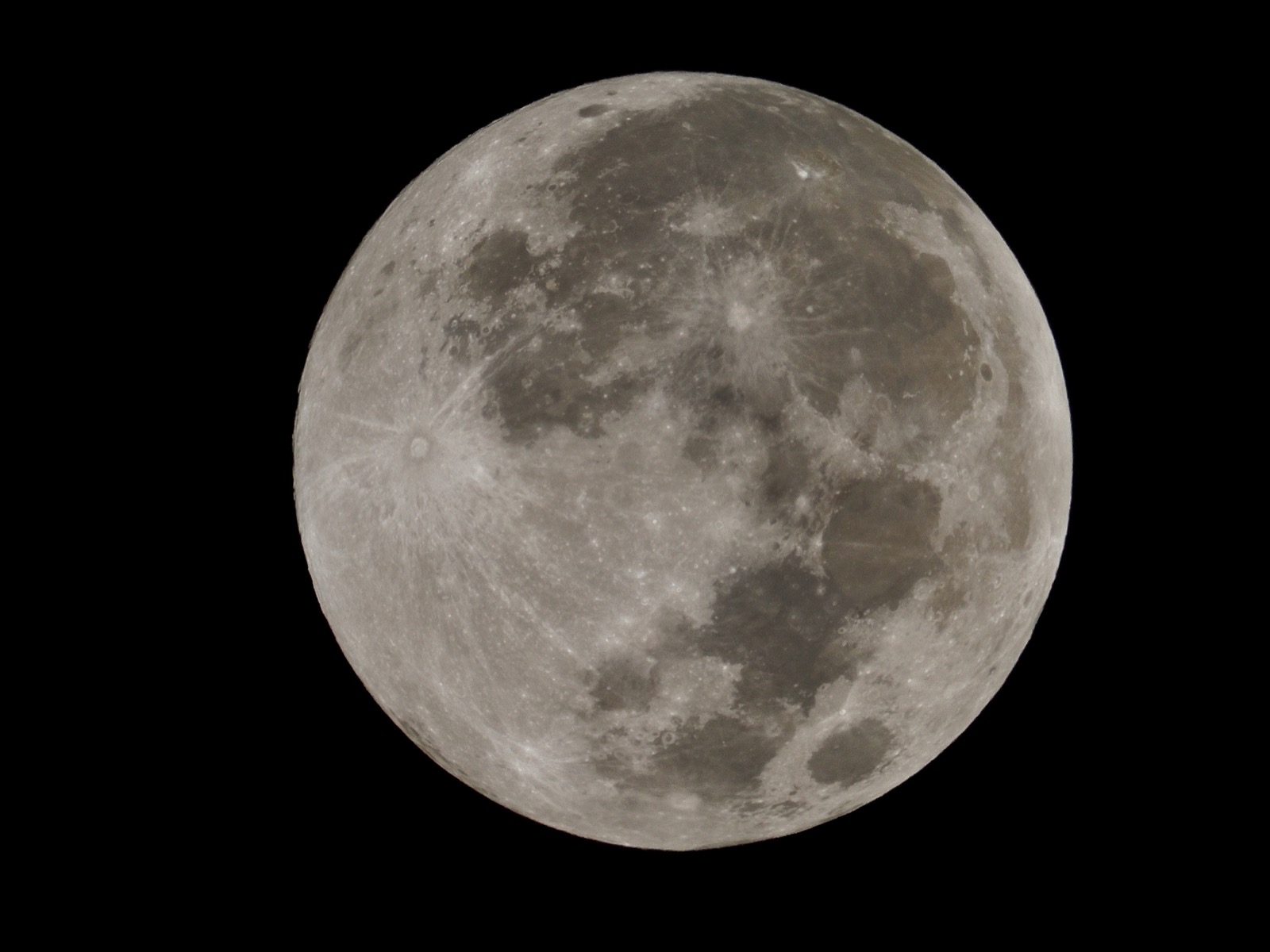 Telephoto closeup of the full moon, technically a couple of hours from being officially 