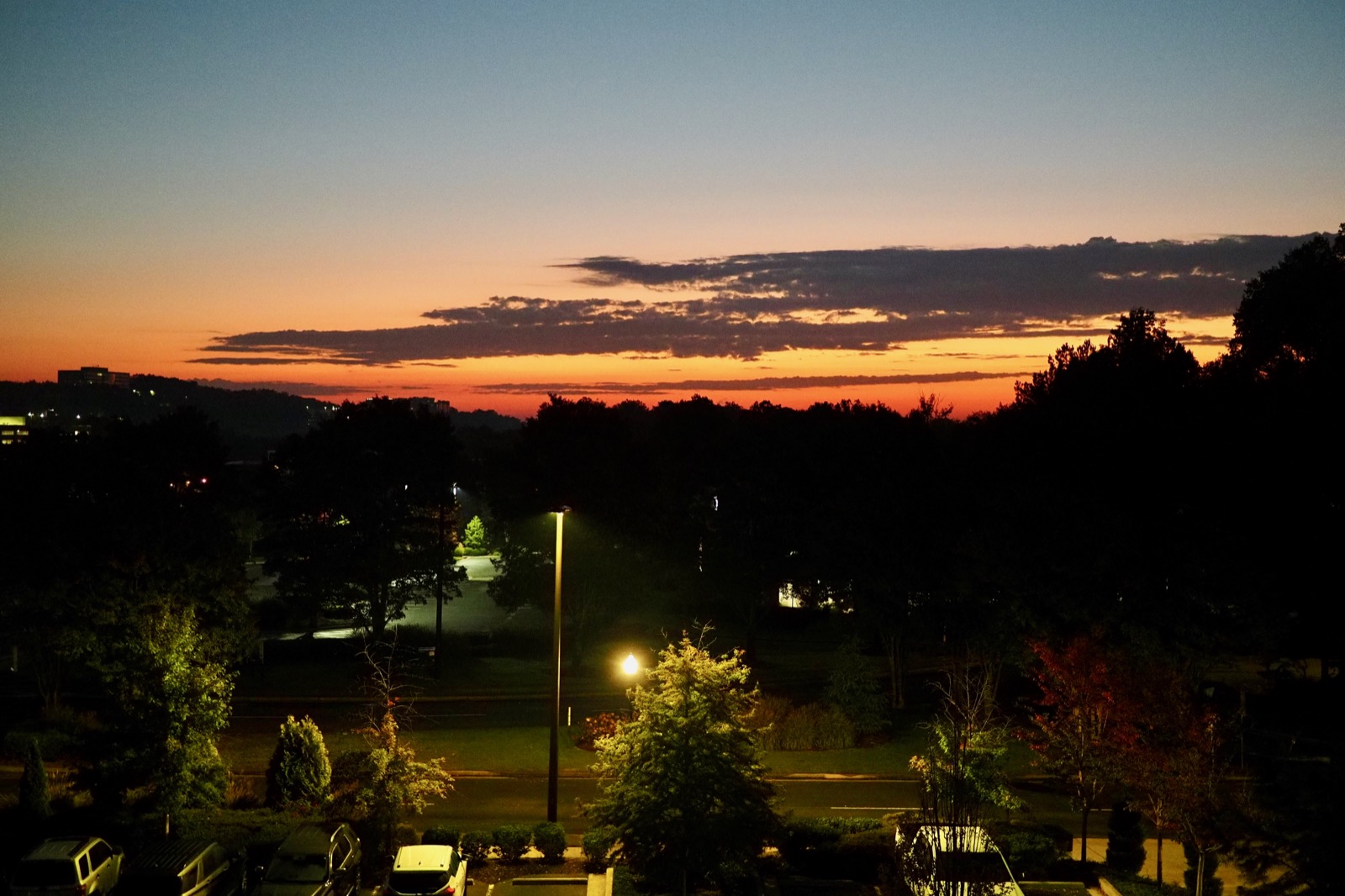 View of the eastern sky at dawn over Alpharetta Georgia, low reddish clouds on the horizon.