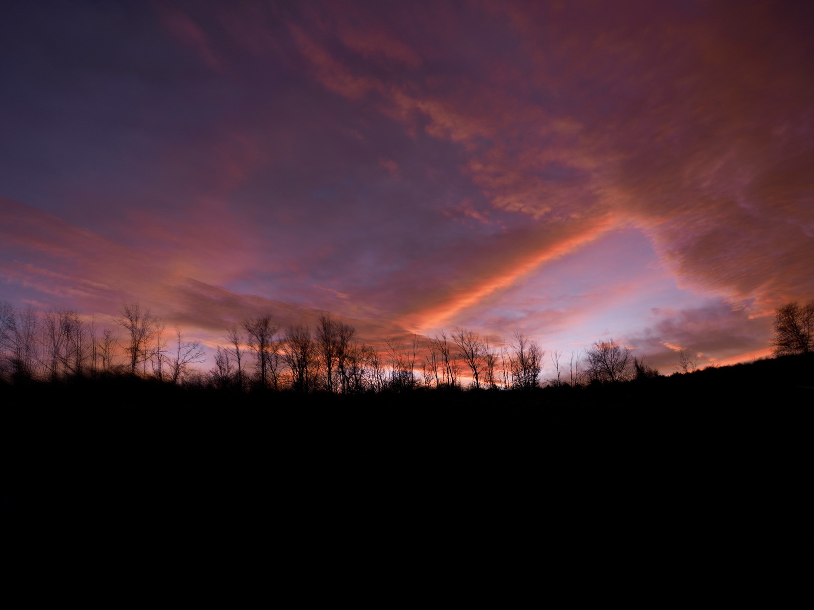 Clouds illuminated from sunlight below the horizon.