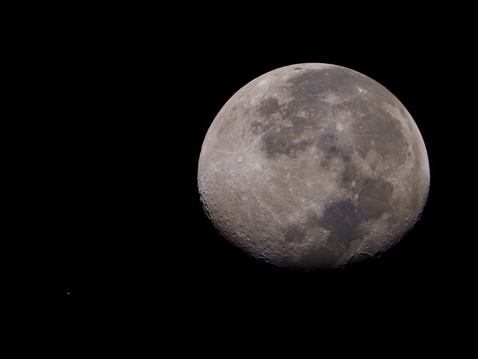 Telephoto closeup of the waning gibbous moon, 88.8% illuminated, with Mars visible in the lower left corner of the frame.