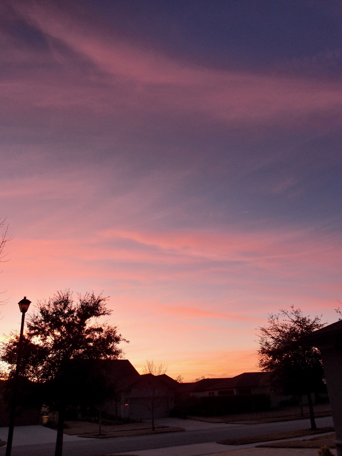 Wispy clouds against a gradient sky after sunset.