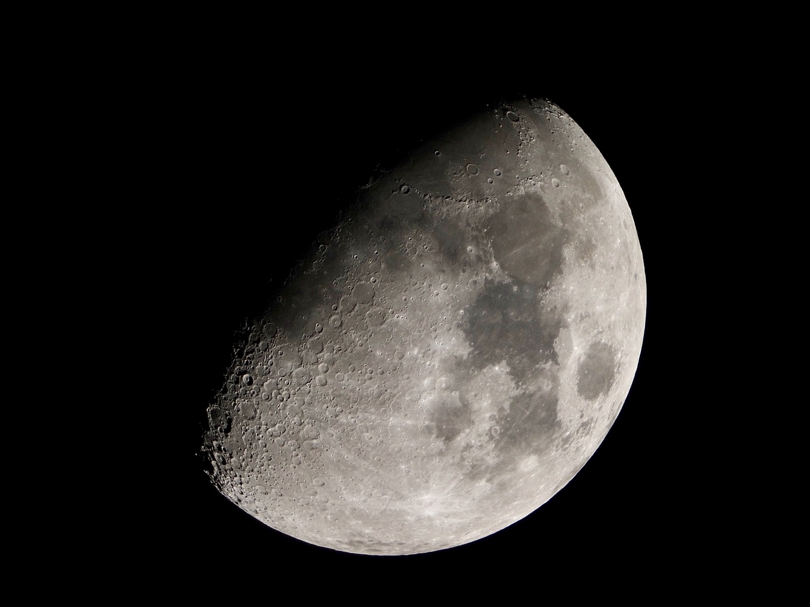 Telephoto closeup of the waxing gibbous moon 65% illuminated