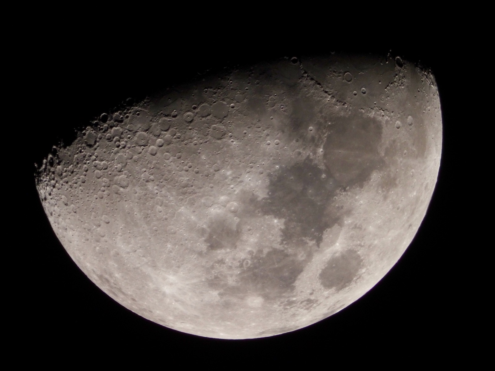 Telephoto closeup of the waxing gibbous moon 58.6% illuminated