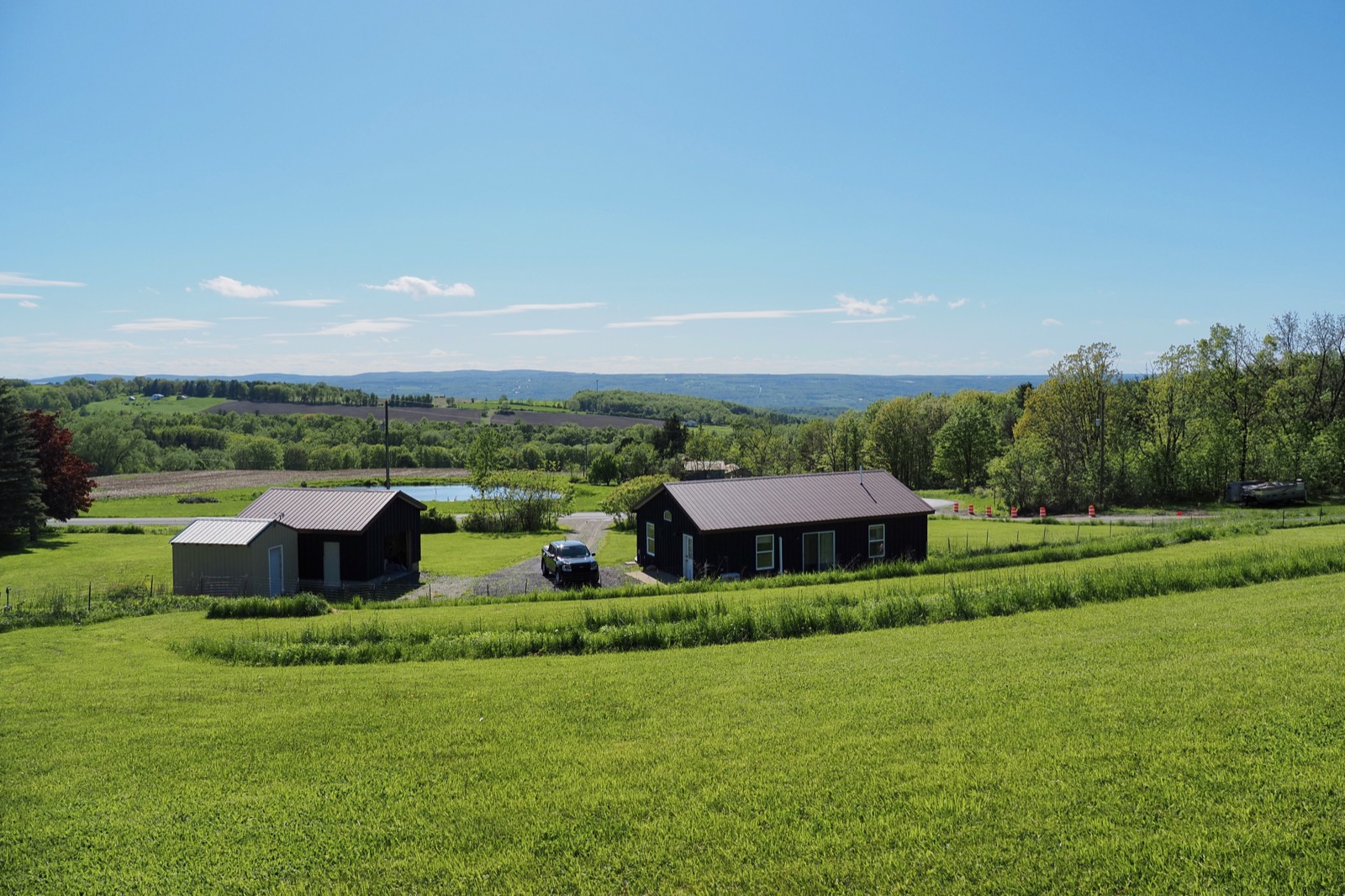 Wideangle landscape image of a rural homestead.