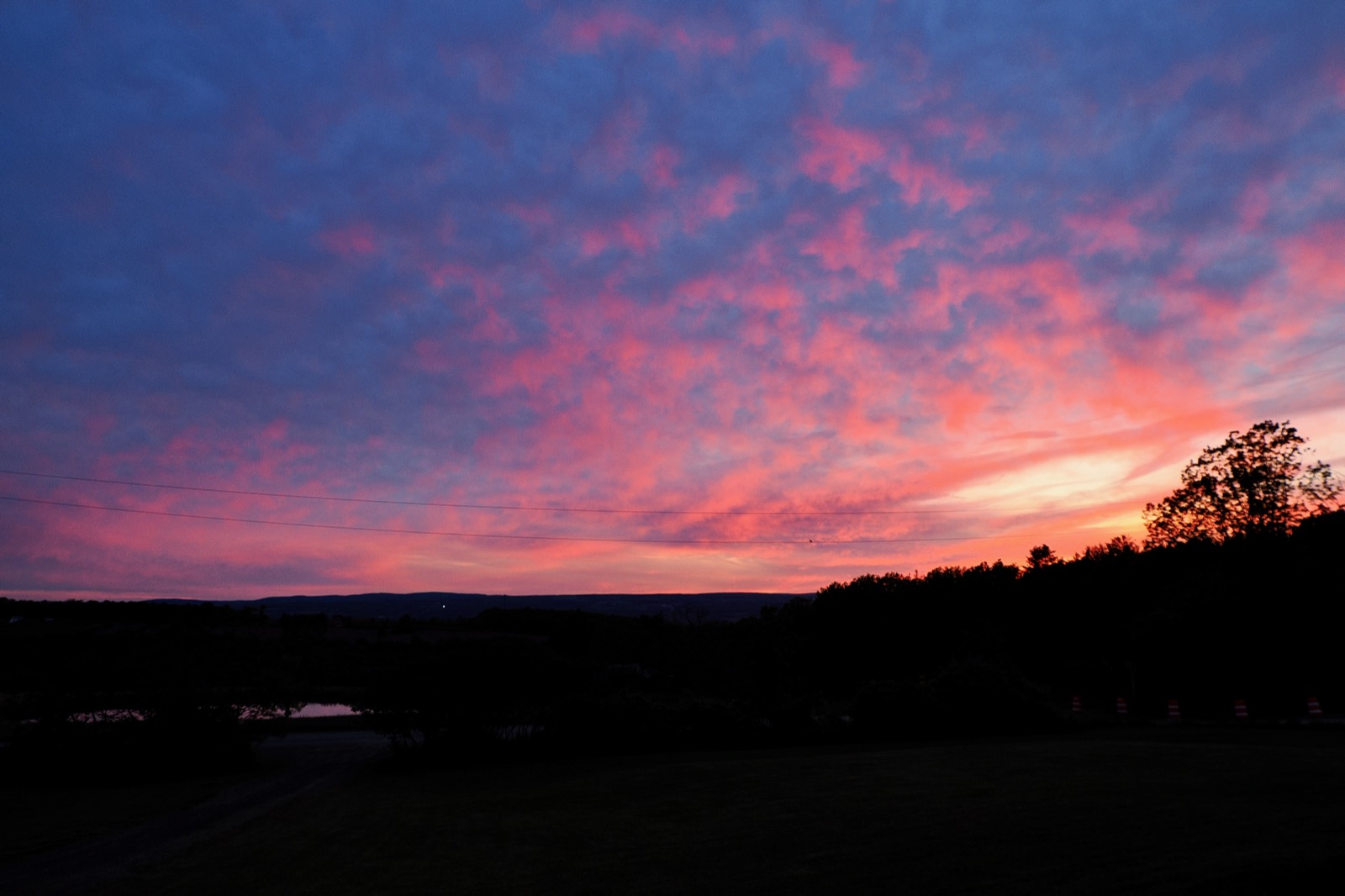 Kind of a mackerel sky illuminated in red from below by the setting sun