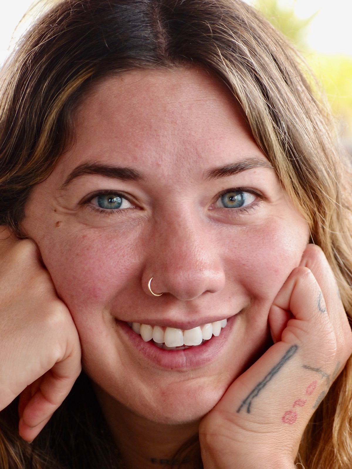 Closeup photography of my daughter's smiling face.