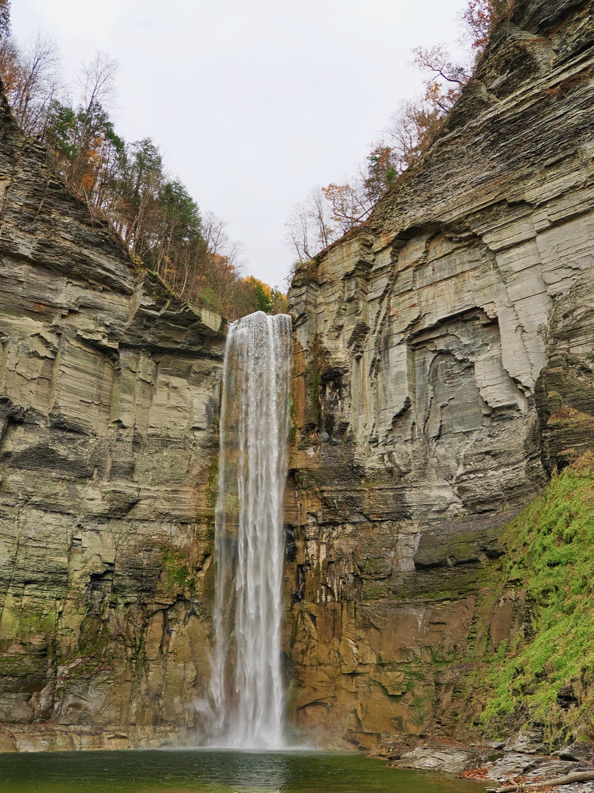 Taughannock Falls from the base of the falls, a high, narrow waterfall in a wide rocky gorge