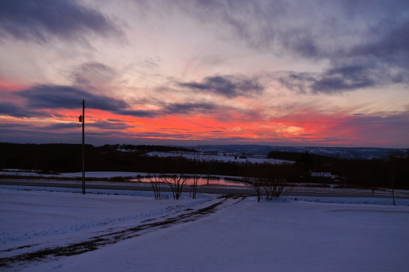 Sunset with some clouds illuminated in red from below.