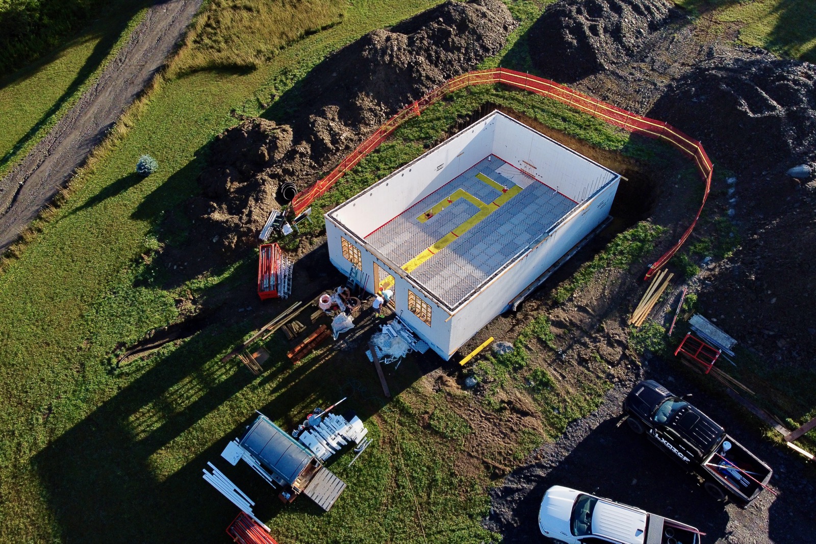 Aerial drone image of a walkout basement with radiant floor insulation and PEX tubing installed.