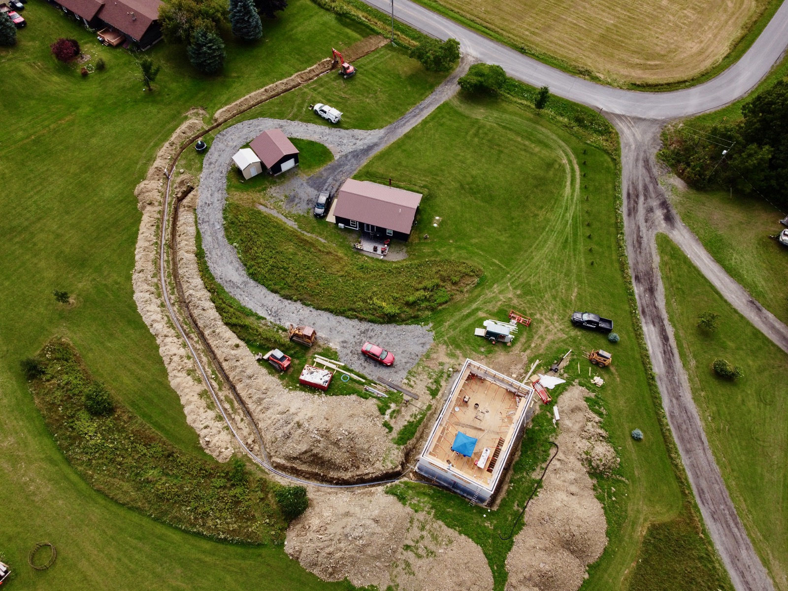 Overhead drone shot of the trench dug for power and water to a new house.