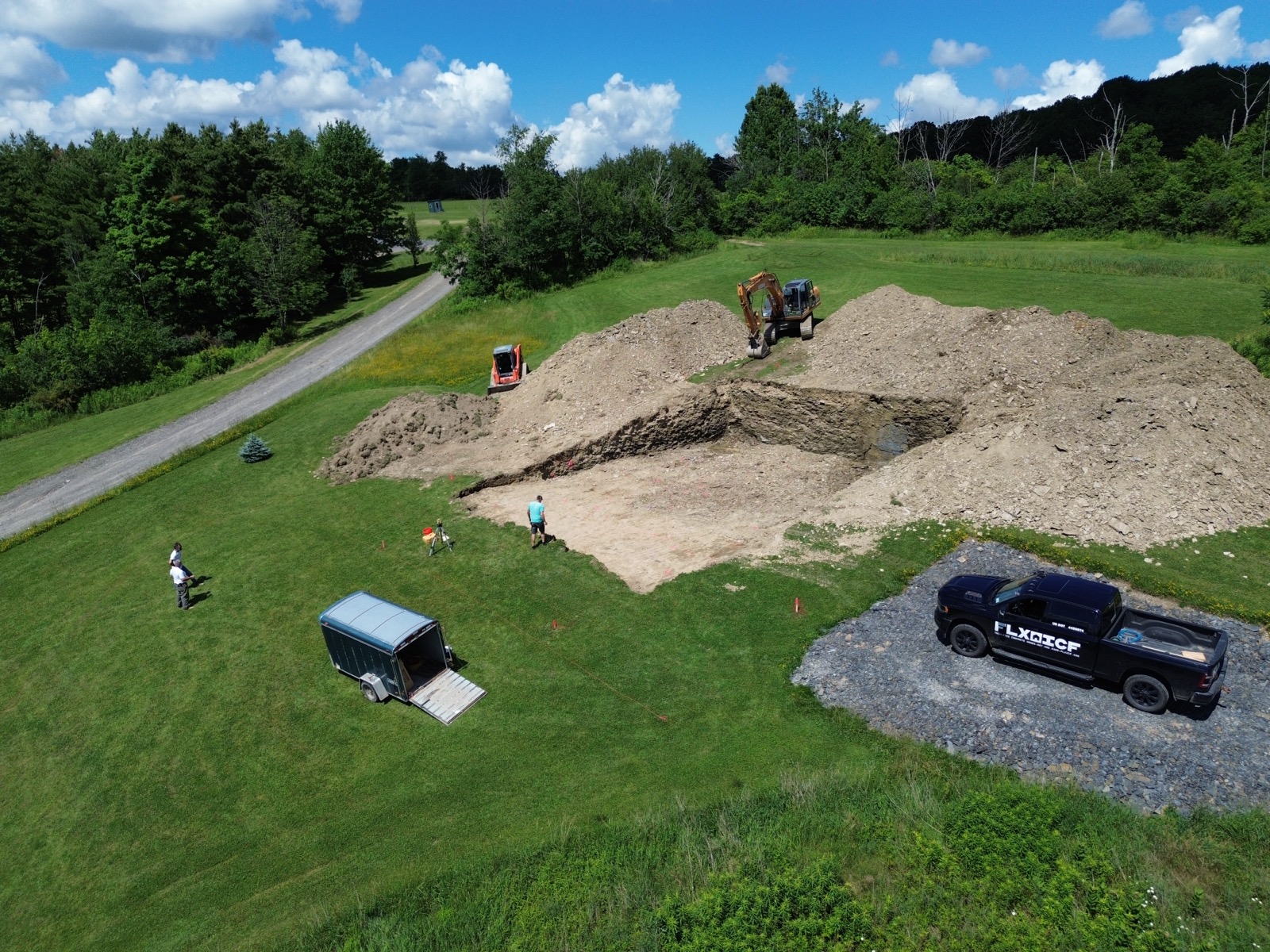 Excavatation in progress in a rural hillside.