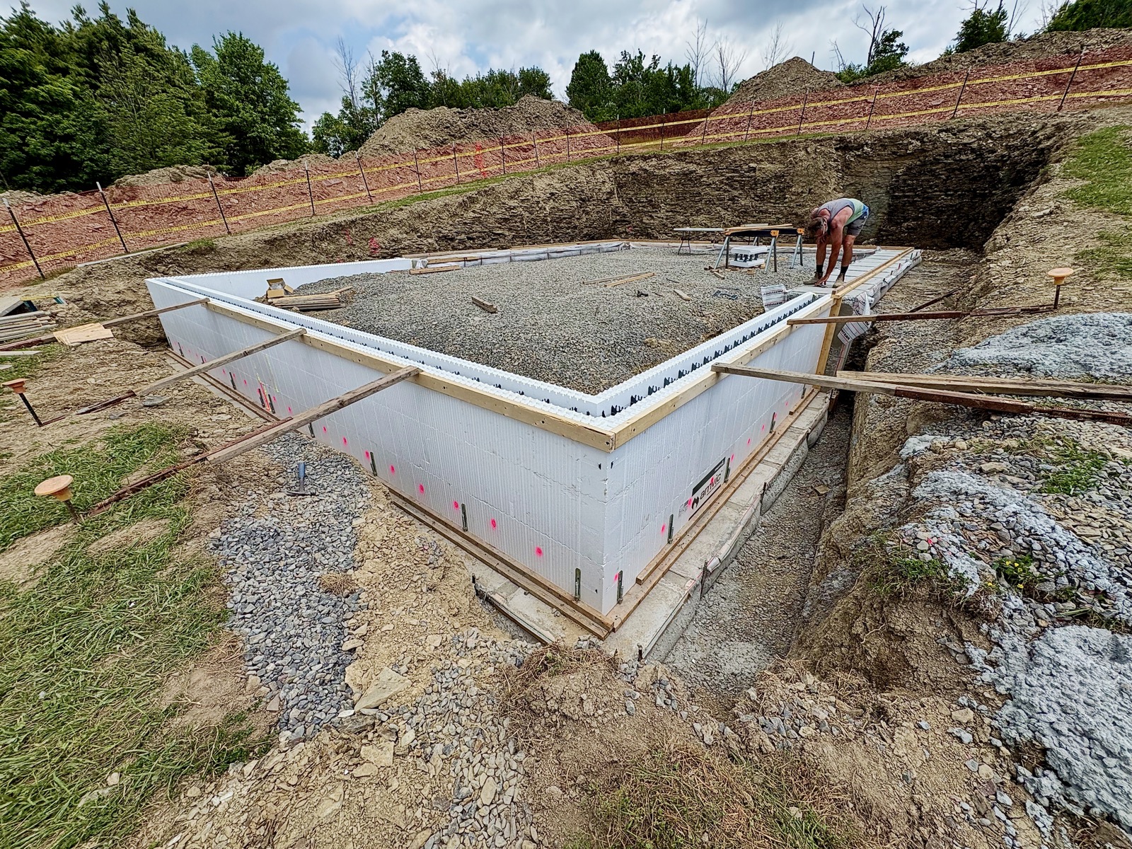 ICF forms stacked above a stepped footing to form a frost wall level with the rest of the foundation.