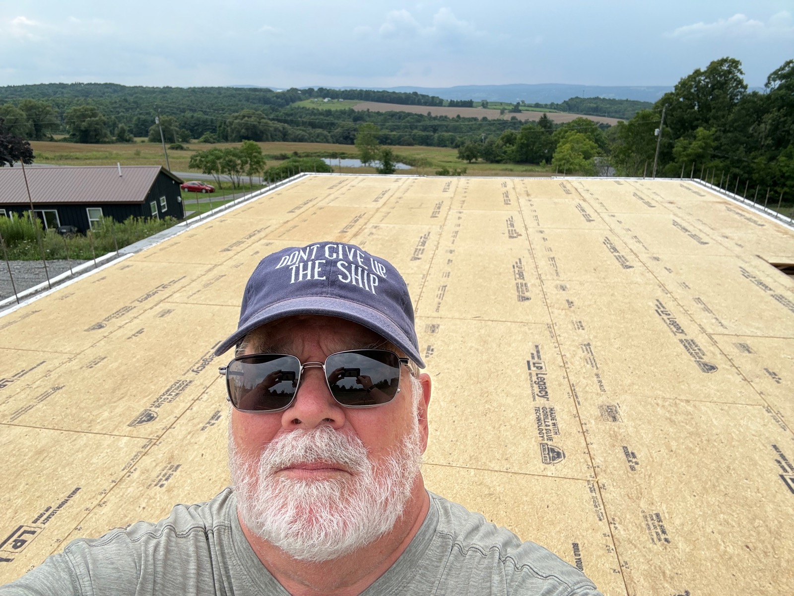 Selfie of me standing on the subflooring above the basement of our new home under construction