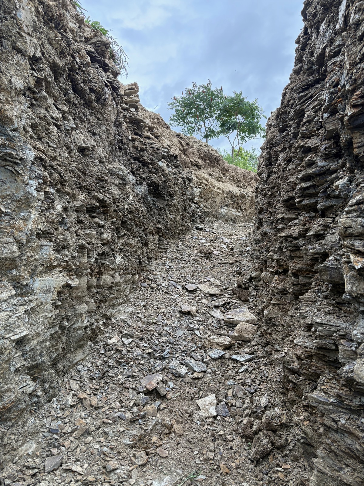 A trench dug to carry water and power to a new house in a bed of shale.