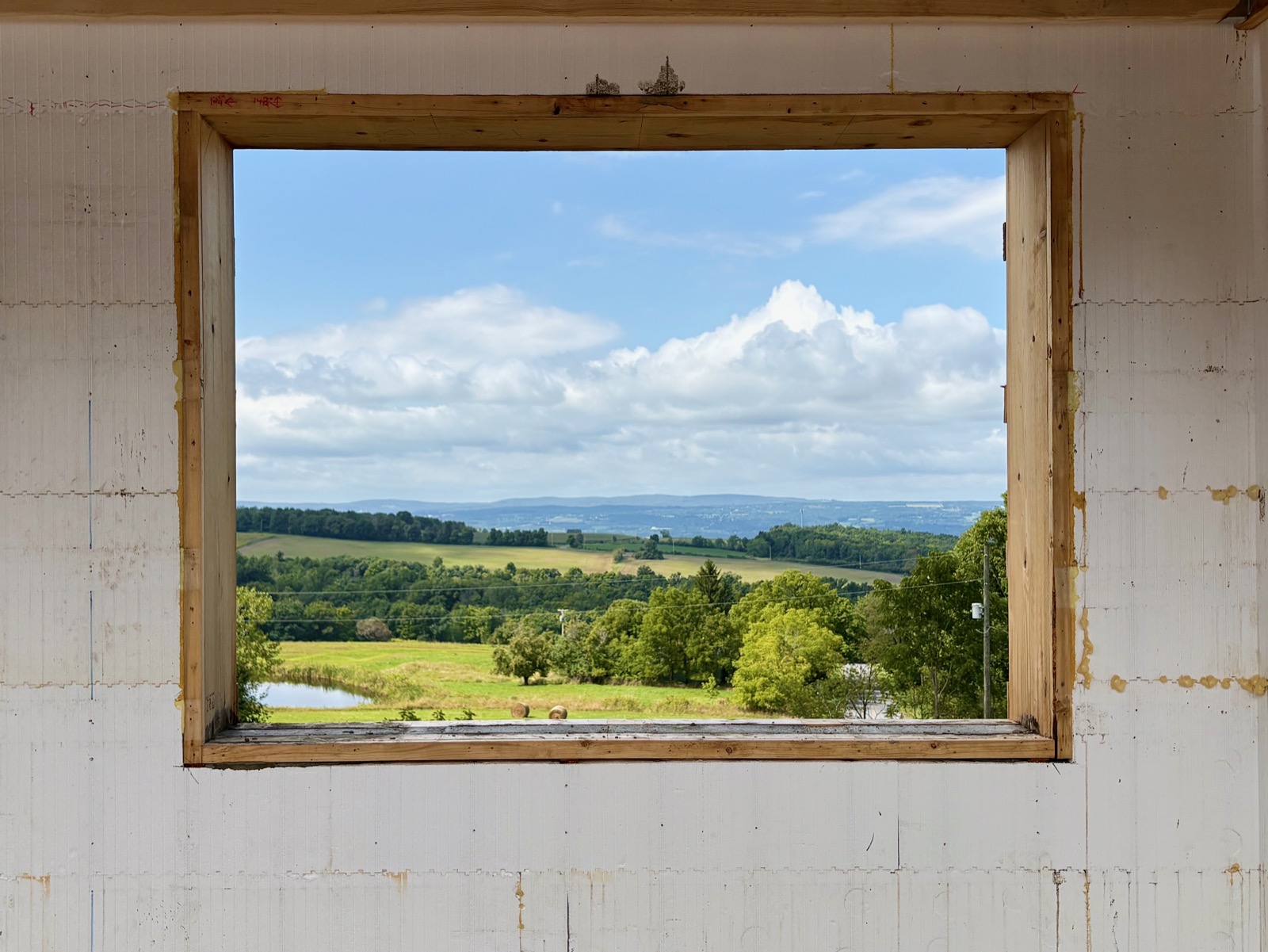 Rural landscape viewed through a window buck for a picture window in an ICF wall.