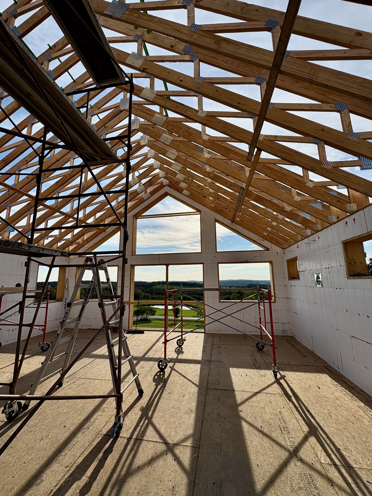 Interior shot of roof trusses above an ICF house under construction.