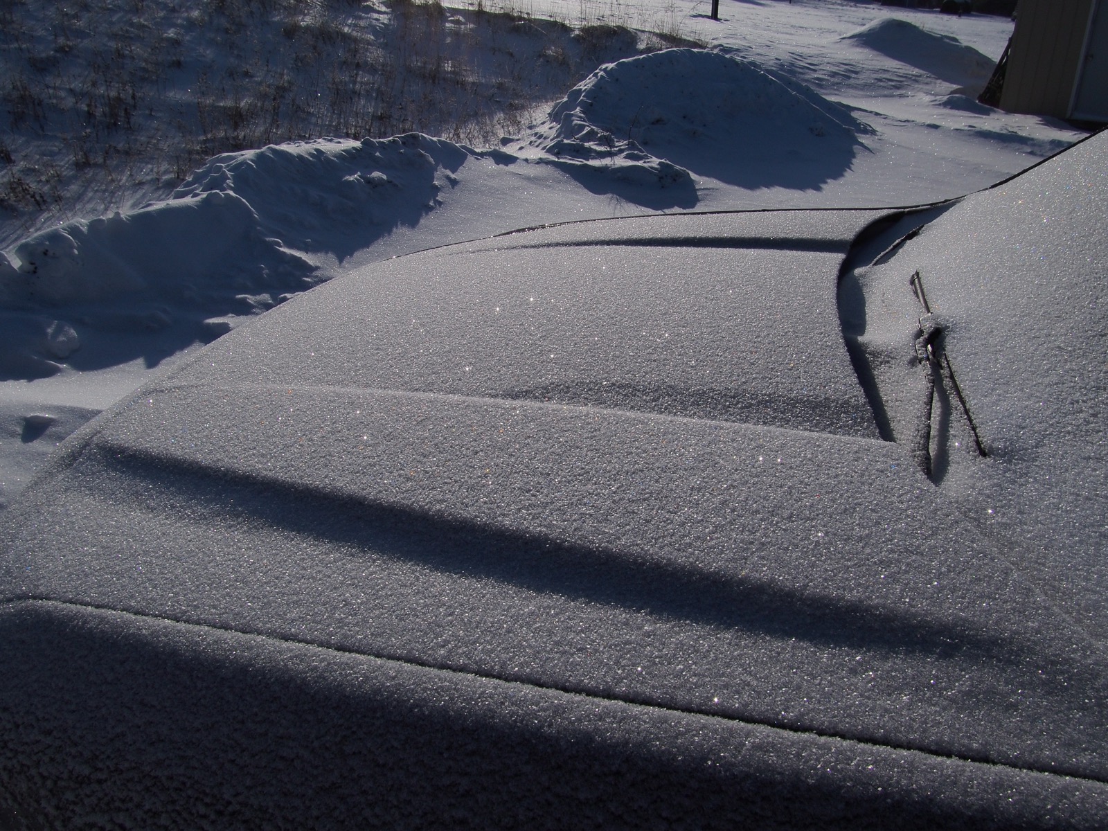 Sparkling snow on the hood of a Ford Maverick