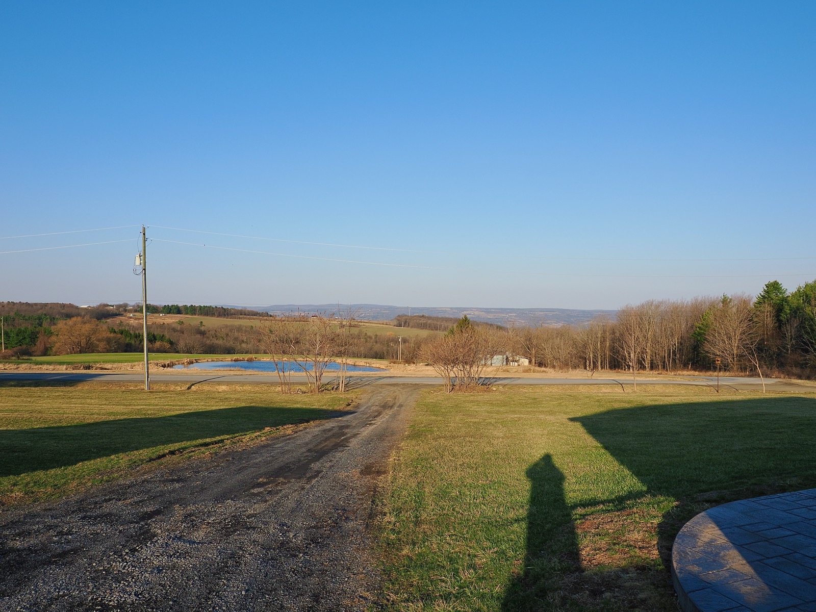 Just a lovely cloudless blue sky above a rural New York landscape