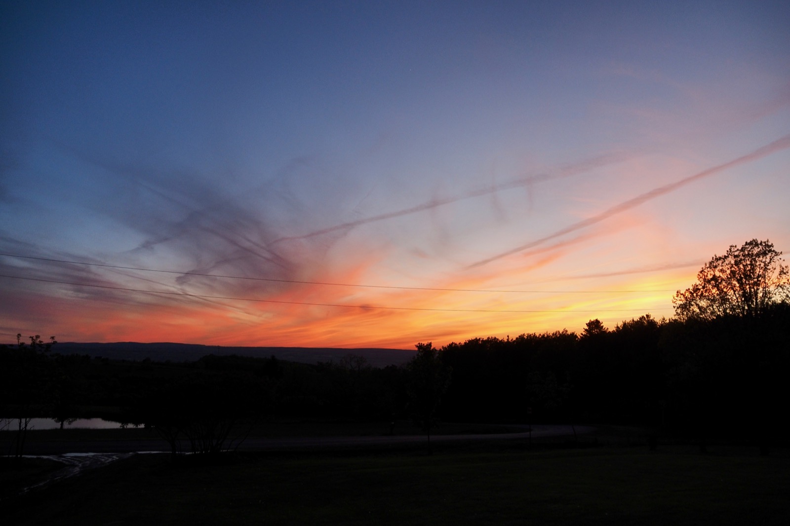 Some clouds illuminated in red and orange from below