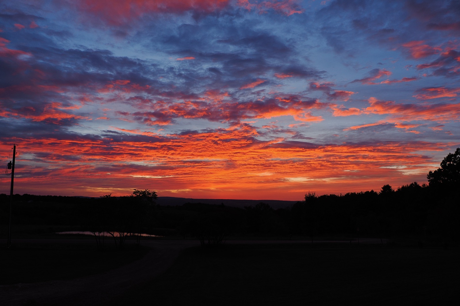 Clouds illuminated from beneath in red and gold
