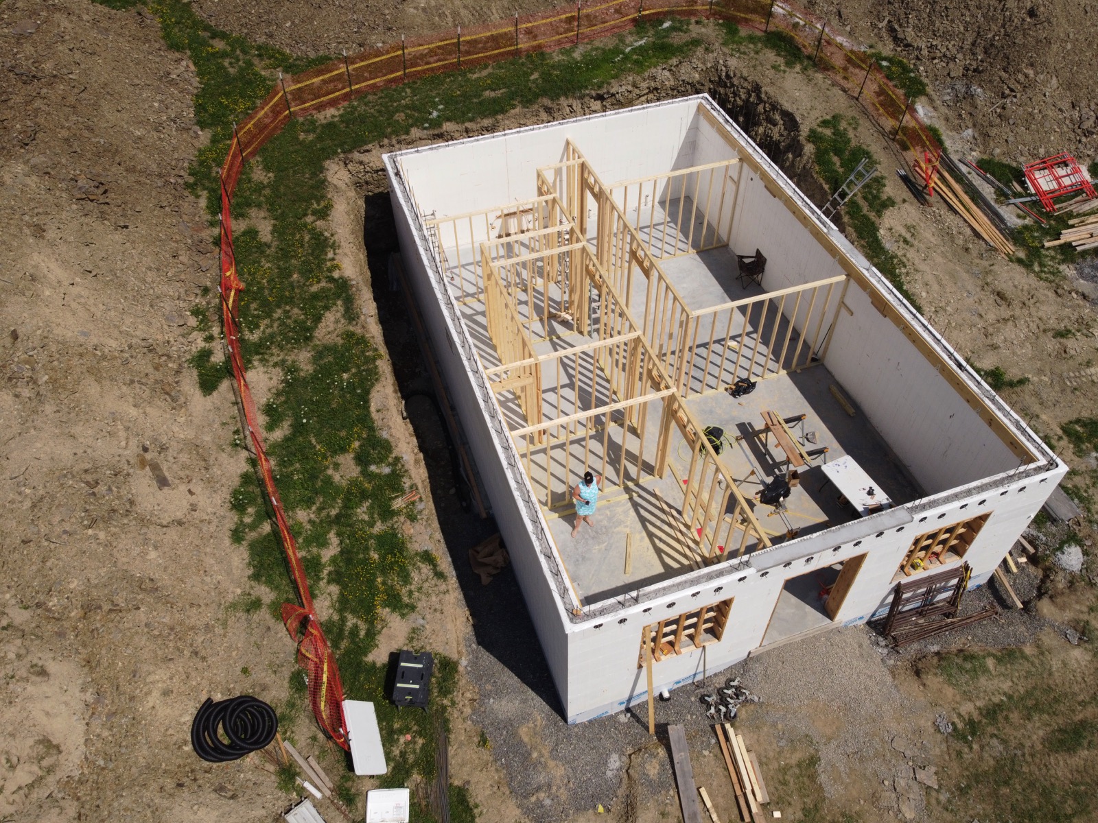 Overhead drone shot of an insulated concrete forms walk-out basement with interior framing.